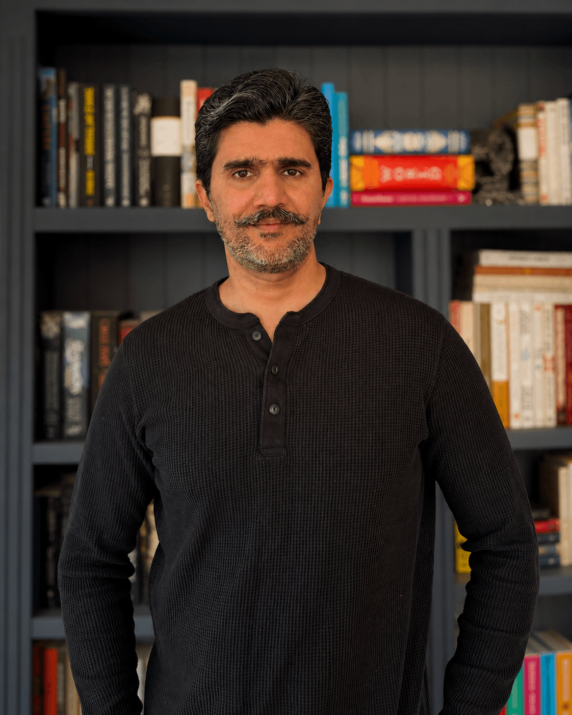 Aviram Vijh in front of a bookshelf